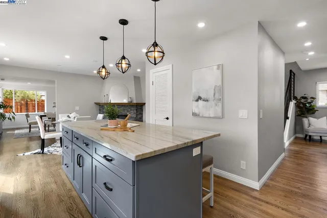 a kitchen with stainless steel appliances granite countertop a sink a stove and a refrigerator