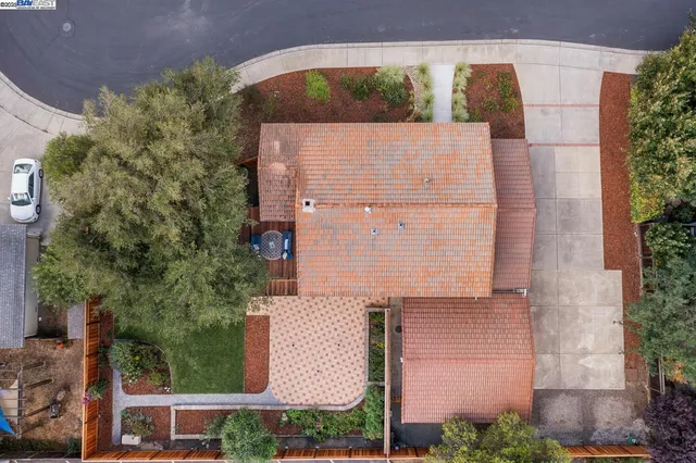 an aerial view of a house with a garden and yard