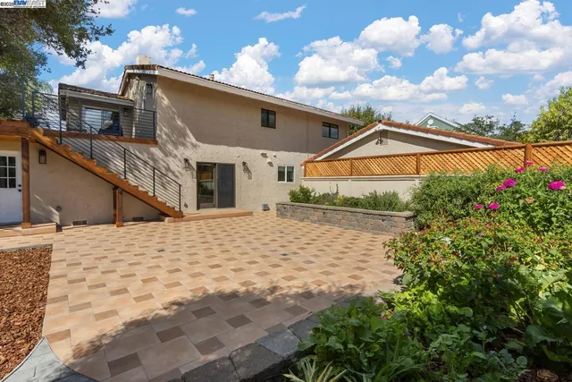 an aerial view of a house with a swimming pool and outdoor seating