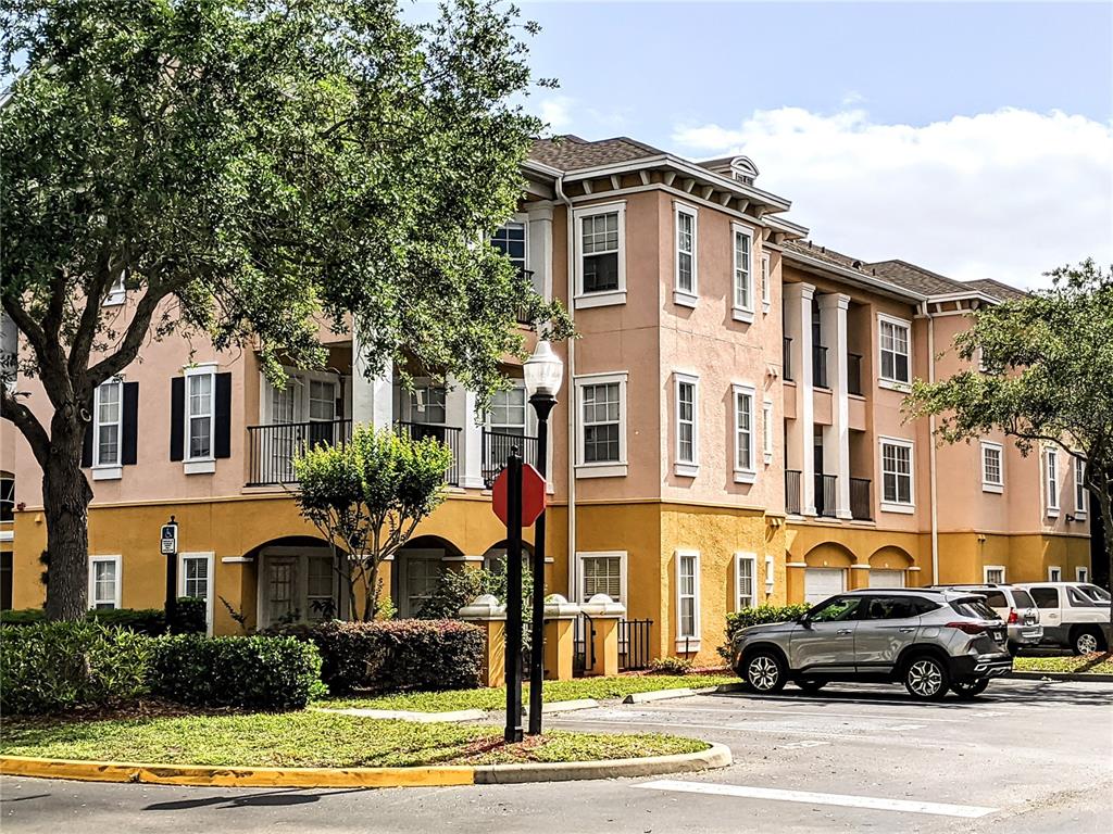 3593 Conroy Road, Unit 424 Orlando, FL 32839 - Photo 1 of 1 a front view of a residential apartment building with yard