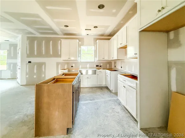 a kitchen with a sink window and cabinets