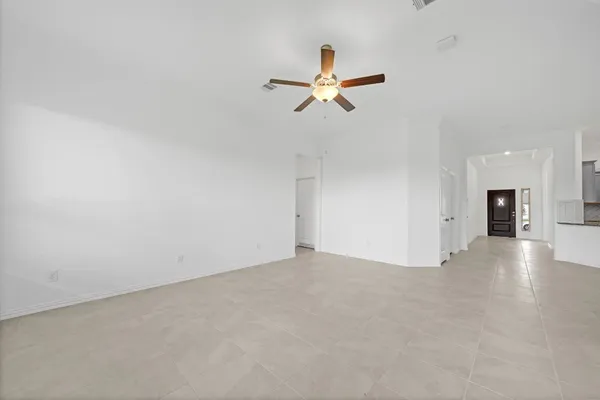 a view of a livingroom with a ceiling fan and window