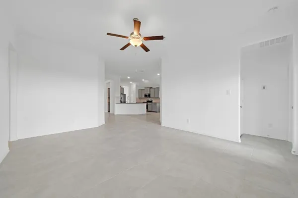 a view of a livingroom with a ceiling fan and window