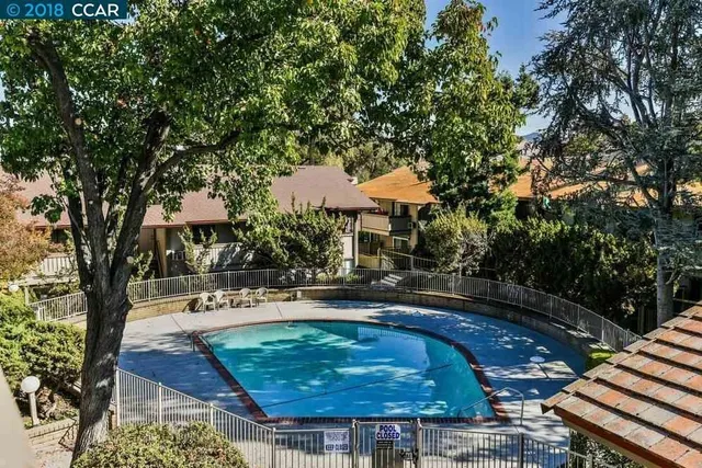 a swimming pool with outdoor seating and yard