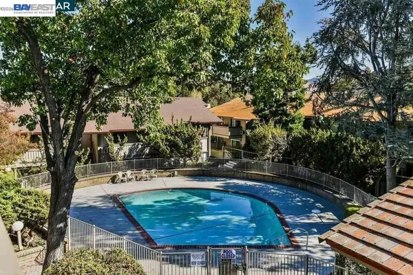 a swimming pool with outdoor seating and yard