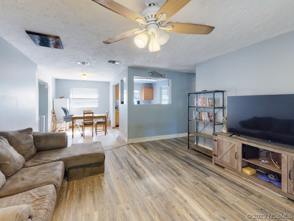 2761 Evergreen Drive Edgewater, FL 32141 - Photo 13 of 61 a living room with furniture and a flat screen tv
