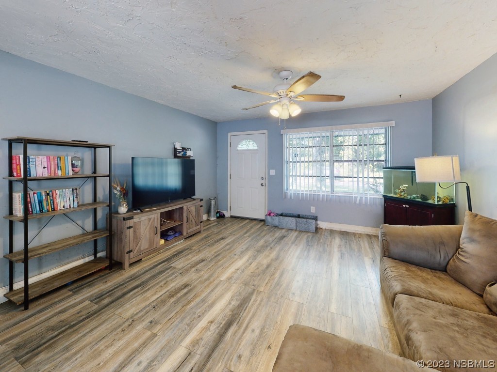 2761 Evergreen Drive Edgewater, FL 32141 - Photo 15 of 61 a living room with furniture and a flat screen tv