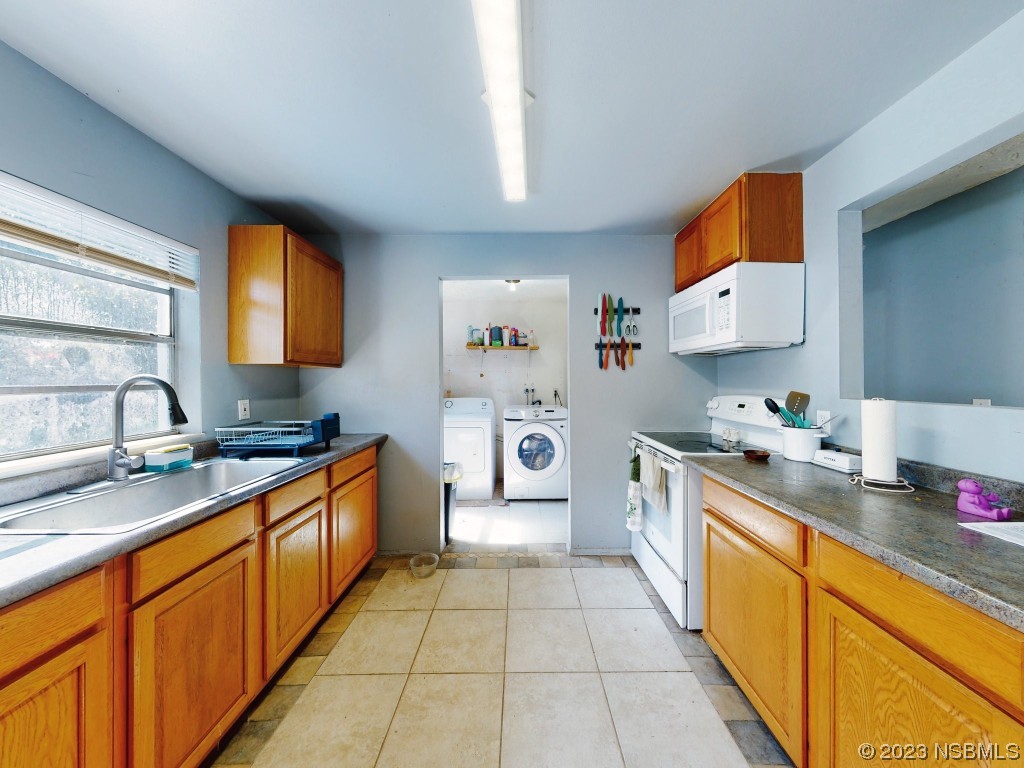 2761 Evergreen Drive Edgewater, FL 32141 - Photo 18 of 61 a large kitchen with stainless steel appliances granite countertop a sink and cabinets