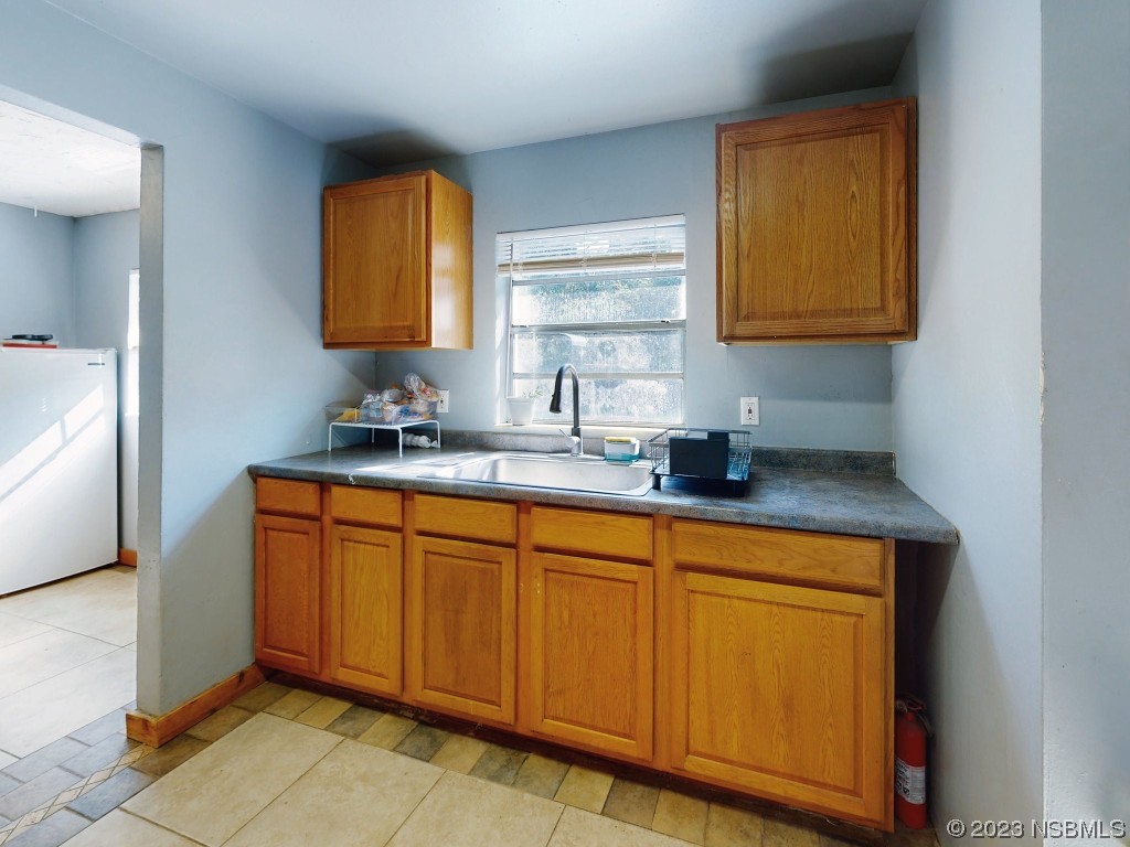 2761 Evergreen Drive Edgewater, FL 32141 - Photo 20 of 61 a kitchen with stainless steel appliances granite countertop a sink and a cabinets