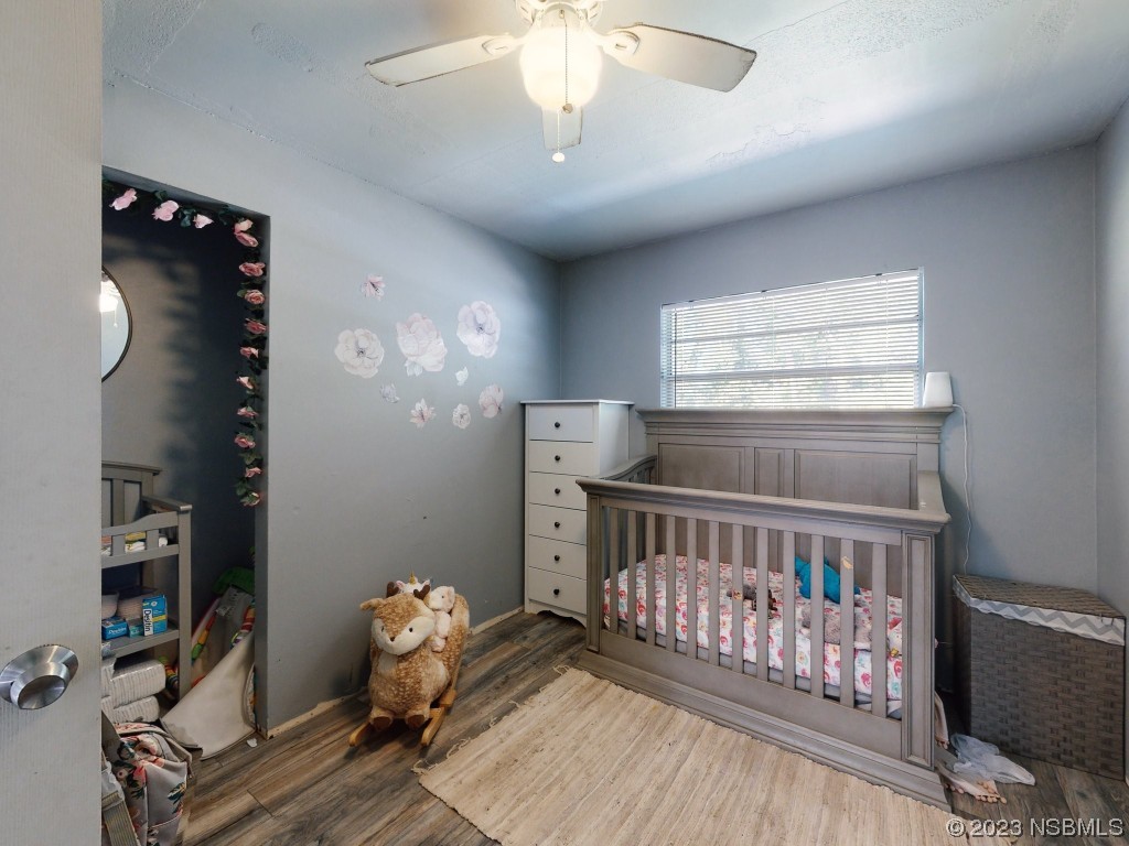 2761 Evergreen Drive Edgewater, FL 32141 - Photo 27 of 61 a bedroom with furniture and wooden floor