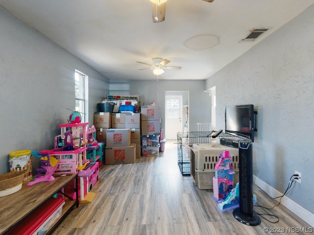 2761 Evergreen Drive Edgewater, FL 32141 - Photo 43 of 61 a room with furniture and a wooden floor