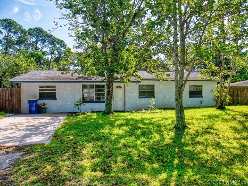 2761 Evergreen Drive Edgewater, FL 32141 - Photo 46 of 61 a front view of a house with a garden