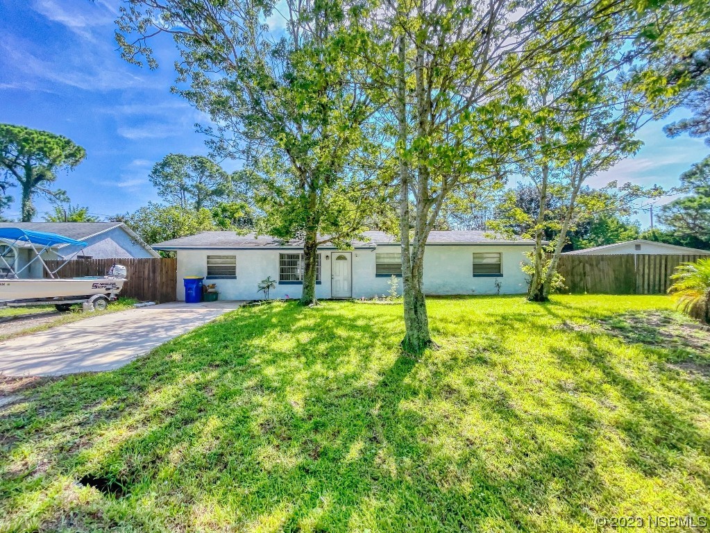 2761 Evergreen Drive Edgewater, FL 32141 - Photo 48 of 61 a front view of a house with a yard and large trees
