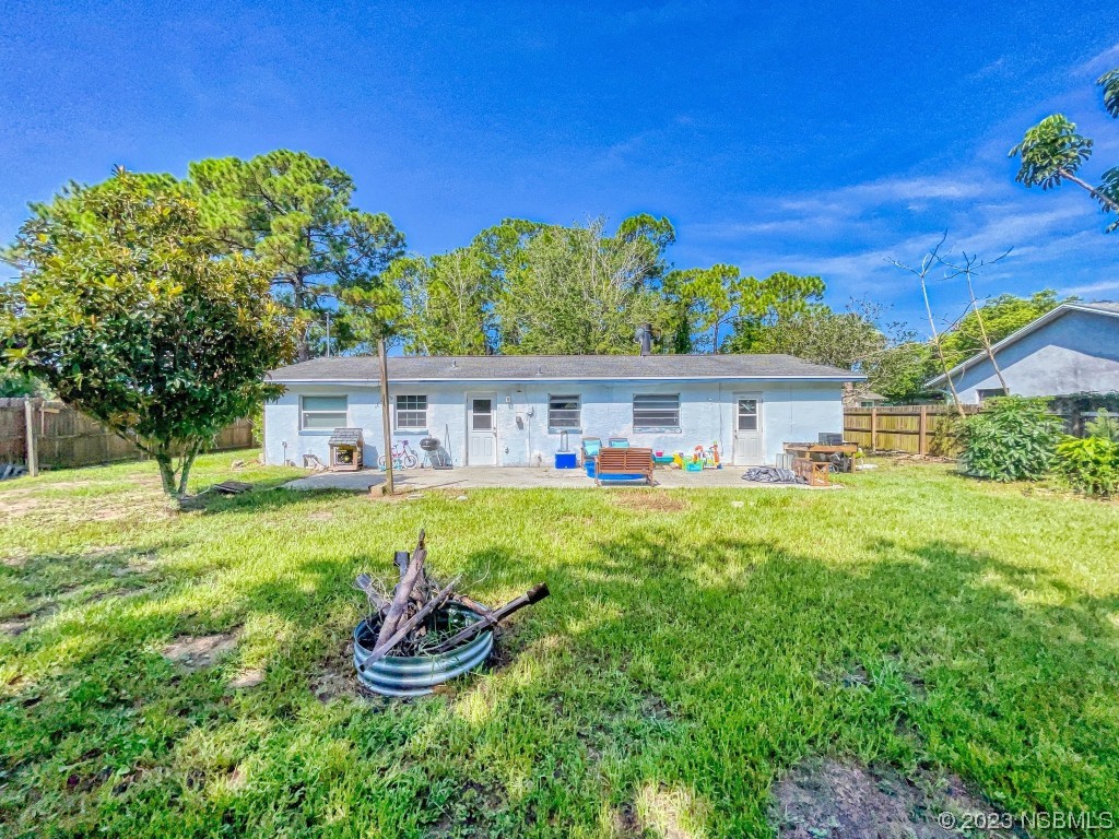 2761 Evergreen Drive Edgewater, FL 32141 - Photo 52 of 61 a front view of a house with a garden and yard