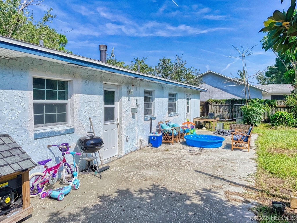 2761 Evergreen Drive Edgewater, FL 32141 - Photo 58 of 61 a view of a patio with table and chairs potted plants