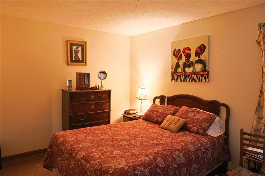 179 College Street Luthersville, GA 30251 - Photo 12 of 26 a bedroom with a bed and painting on the wall