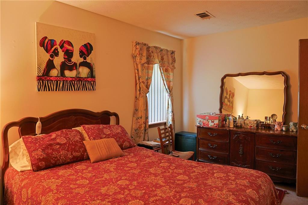 179 College Street Luthersville, GA 30251 - Photo 15 of 26 a bedroom with a bed and a dresser