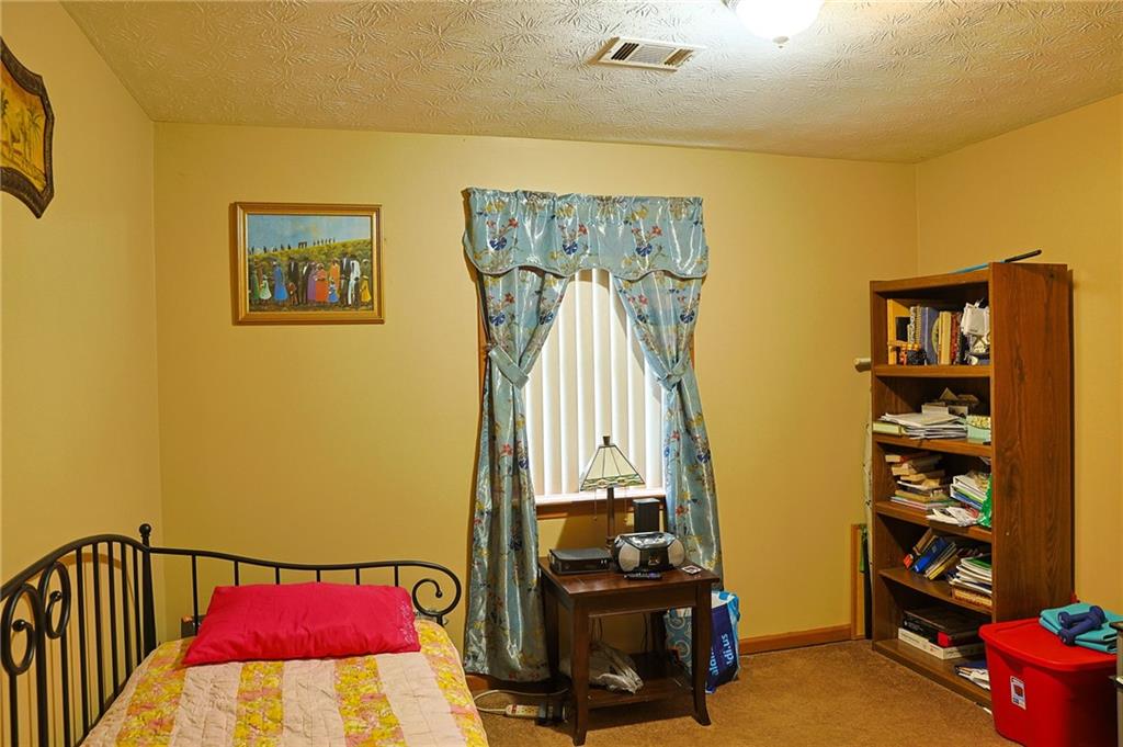 179 College Street Luthersville, GA 30251 - Photo 16 of 26 a view of a room with shelves