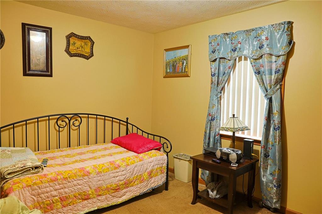 179 College Street Luthersville, GA 30251 - Photo 17 of 26 a bedroom with a bed and a table in it