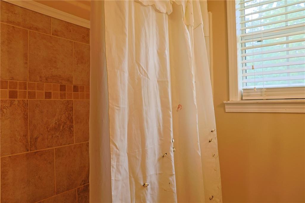 179 College Street Luthersville, GA 30251 - Photo 20 of 26 a bathroom with a shower curtain
