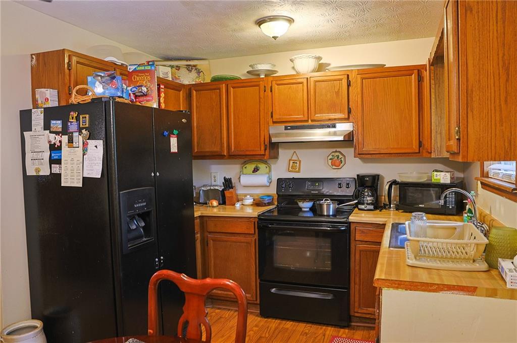 179 College Street Luthersville, GA 30251 - Photo 9 of 26 a kitchen with granite countertop a refrigerator stove and sink