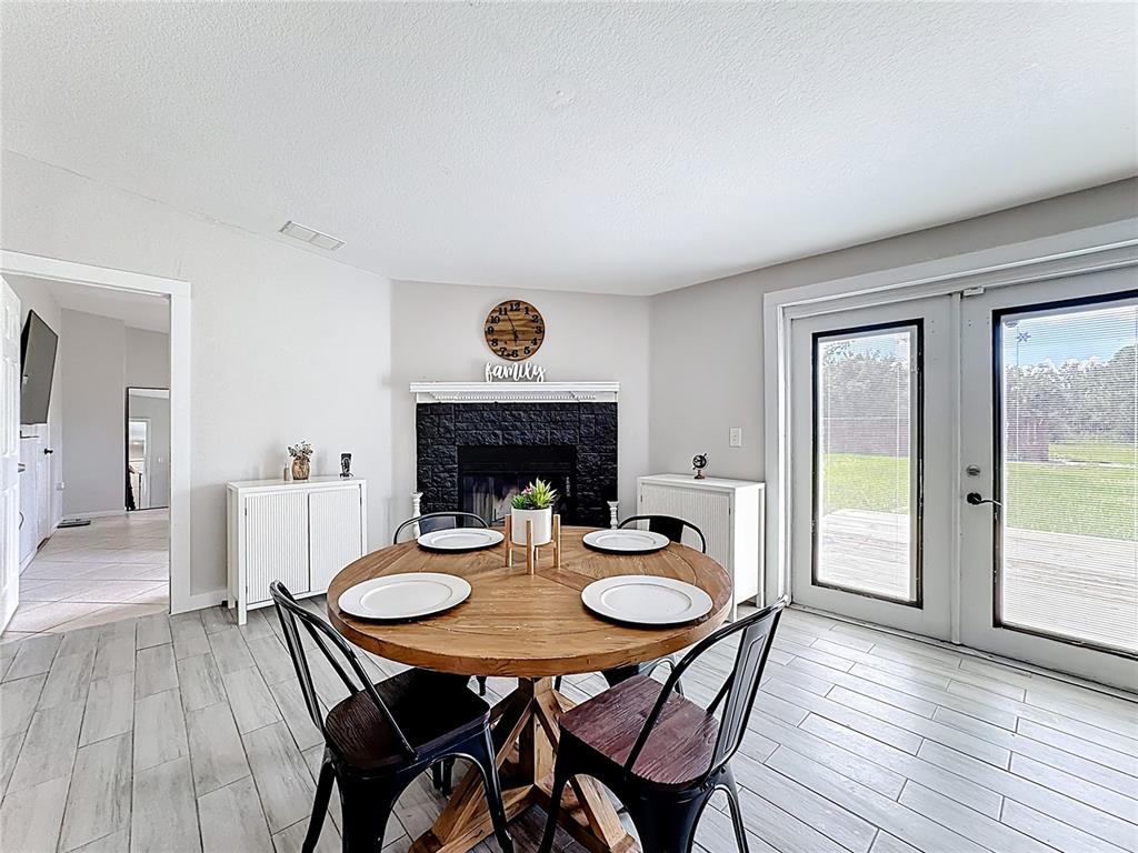 18604 Belvedere Road Orlando, FL 32820 - Photo 13 of 50 a view of a dining room with furniture and wooden floor