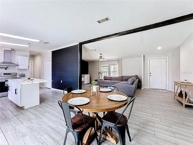 a view of a dining room with furniture window and wooden floor