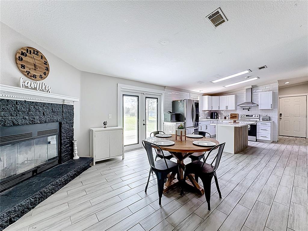 18604 Belvedere Road Orlando, FL 32820 - Photo 16 of 50 a view of a dining room with furniture window and wooden floor
