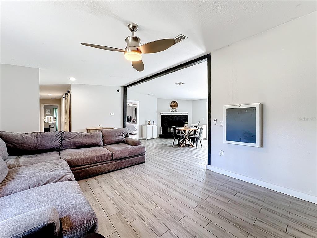 18604 Belvedere Road Orlando, FL 32820 - Photo 17 of 50 a living room with furniture and a wooden floor