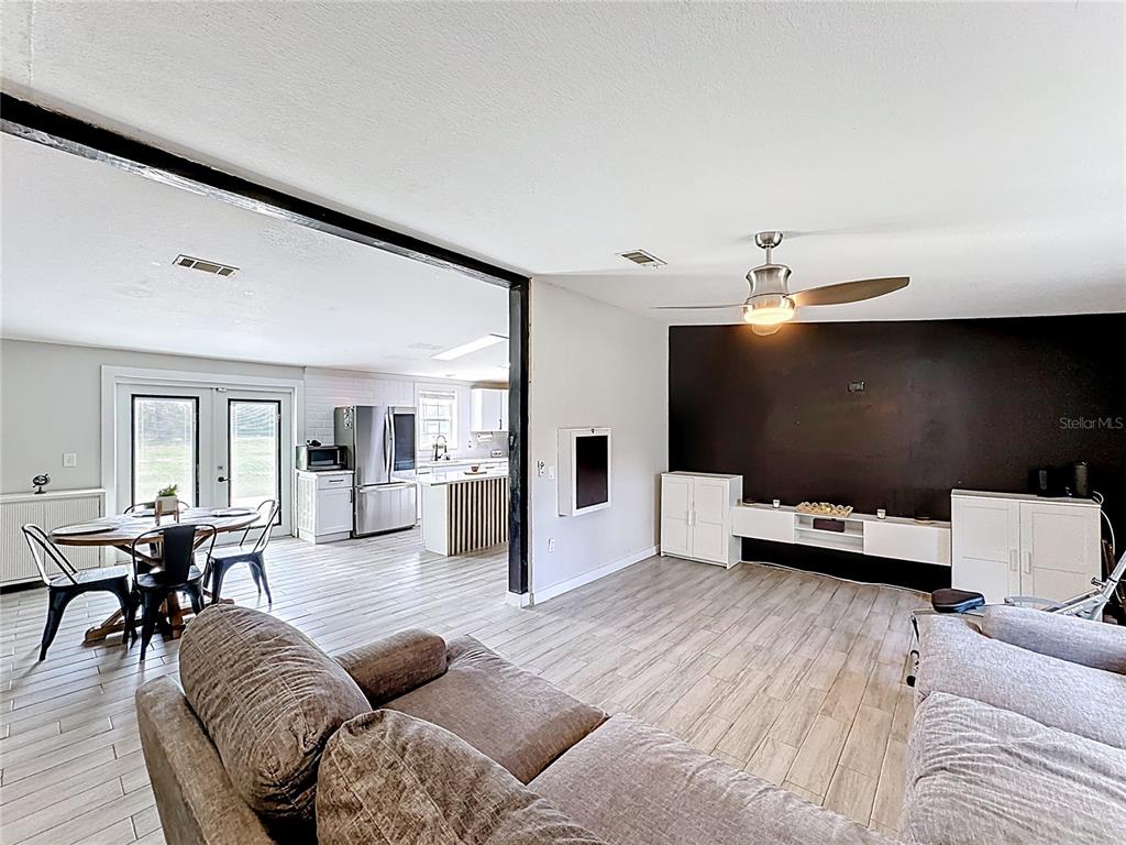 18604 Belvedere Road Orlando, FL 32820 - Photo 18 of 50 a living room with furniture and a flat screen tv