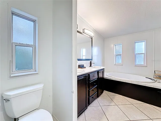 a kitchen with a refrigerator and a sink