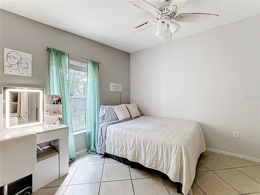 18604 Belvedere Road Orlando, FL 32820 - Photo 29 of 50 a bedroom with a bed and a chandelier