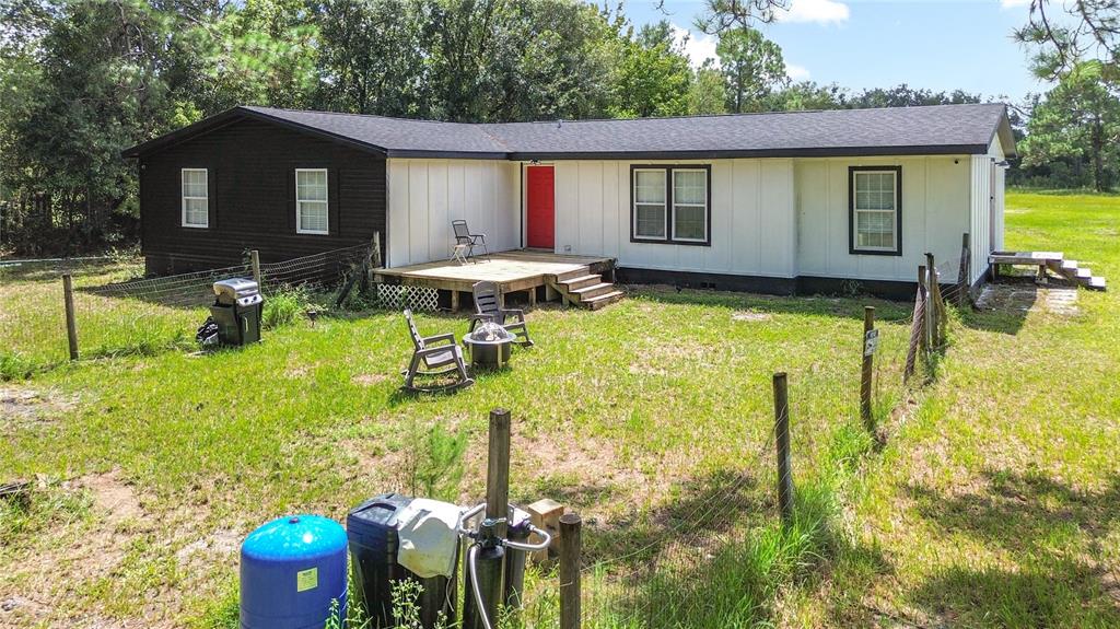 18604 Belvedere Road Orlando, FL 32820 - Photo 3 of 50 a front view of house with yard having outdoor seating