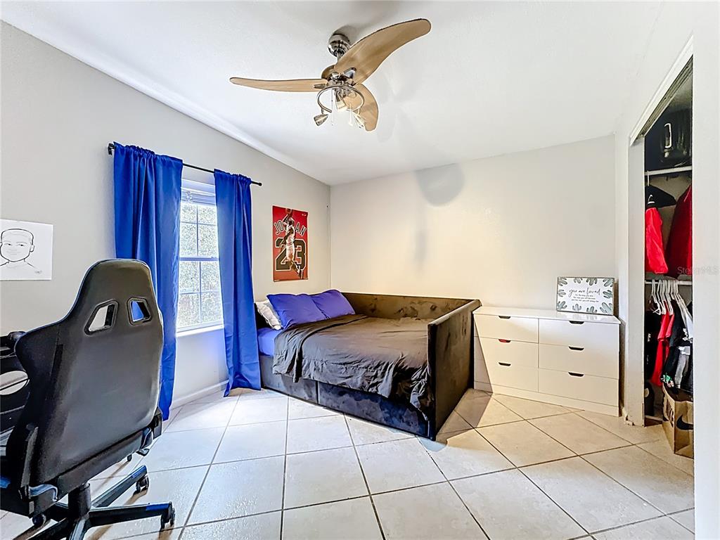 18604 Belvedere Road Orlando, FL 32820 - Photo 32 of 50 a spacious bedroom with a bed and cabinets