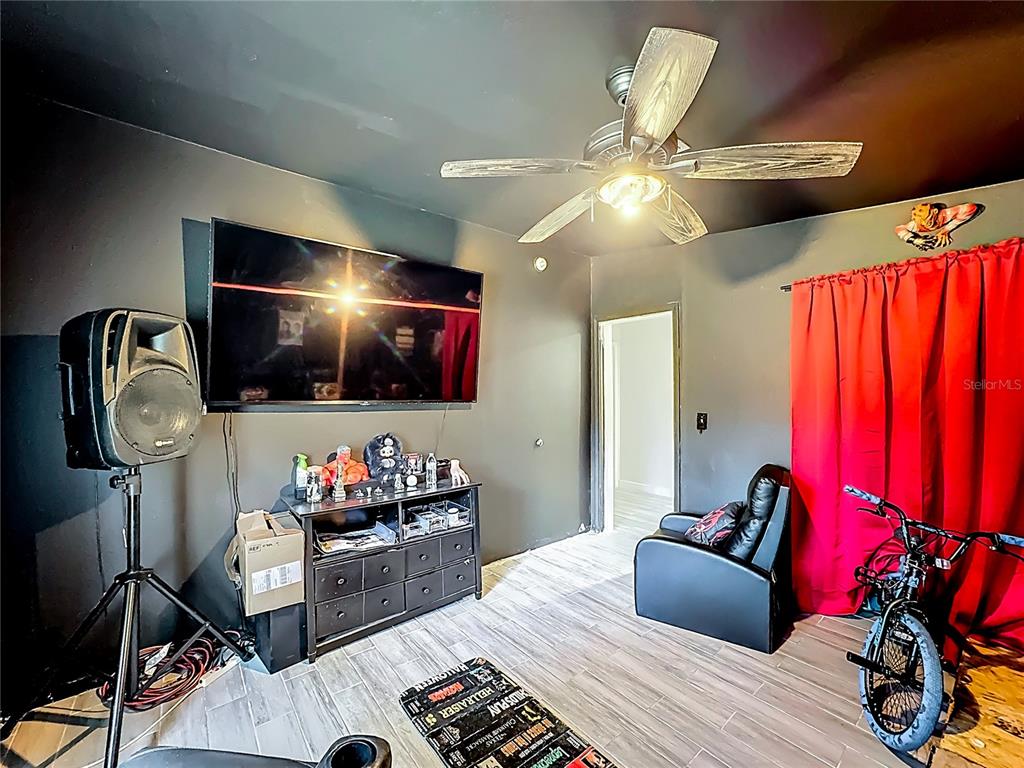 18604 Belvedere Road Orlando, FL 32820 - Photo 33 of 50 a bedroom with furniture and a flat screen tv