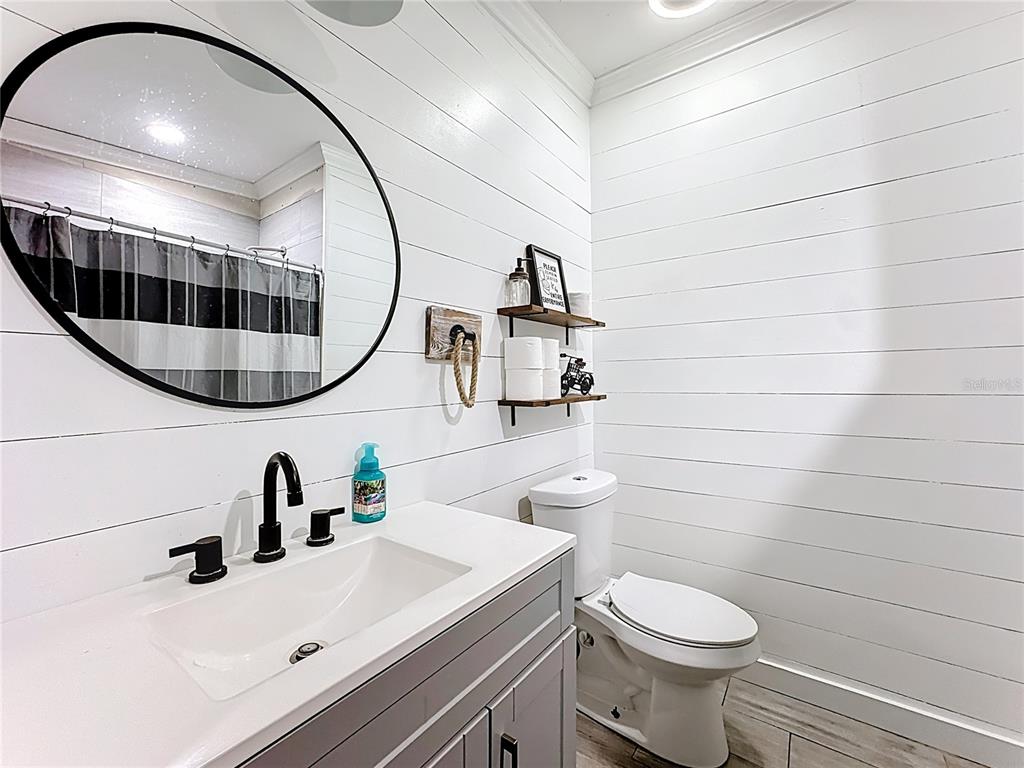 18604 Belvedere Road Orlando, FL 32820 - Photo 35 of 50 a bathroom with a sink a toilet and a mirror