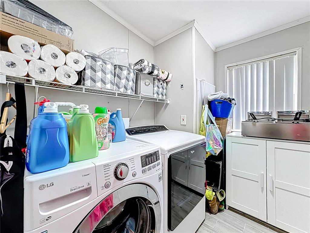 18604 Belvedere Road Orlando, FL 32820 - Photo 37 of 50 a utility room with dryer and washer