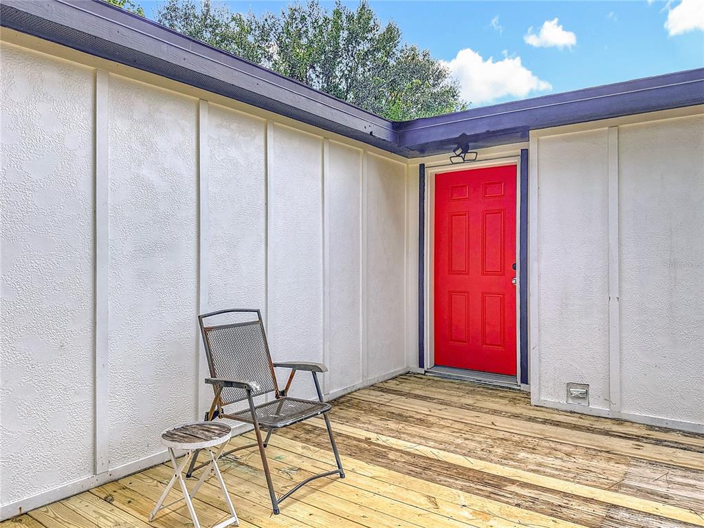 18604 Belvedere Road Orlando, FL 32820 - Photo 38 of 50 a view of a red door and chair in the room