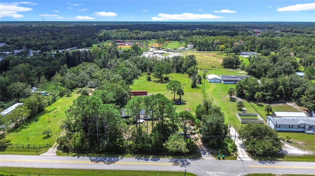 18604 Belvedere Road Orlando, FL 32820 - Photo 43 of 50 an aerial view of residential houses with outdoor space and trees