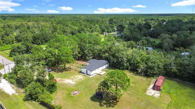 a view of a park with a bench in a garden