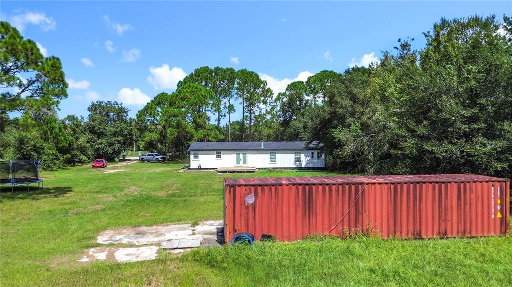 18604 Belvedere Road Orlando, FL 32820 - Photo 46 of 50 a view of a backyard with a garden