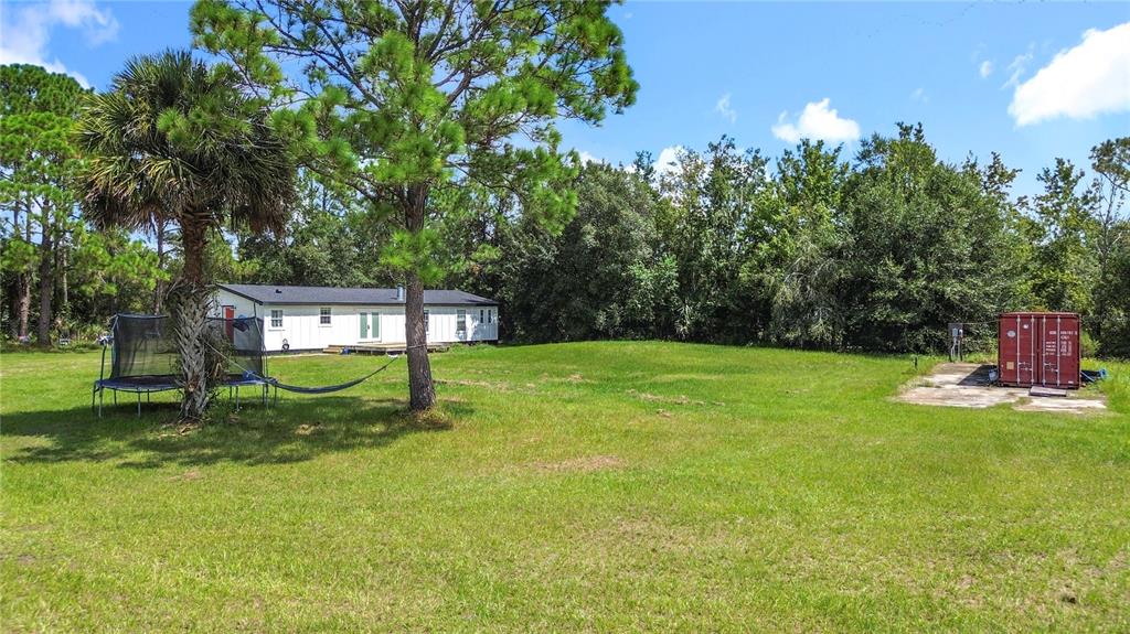 18604 Belvedere Road Orlando, FL 32820 - Photo 47 of 50 a view of a park with a bench in a garden