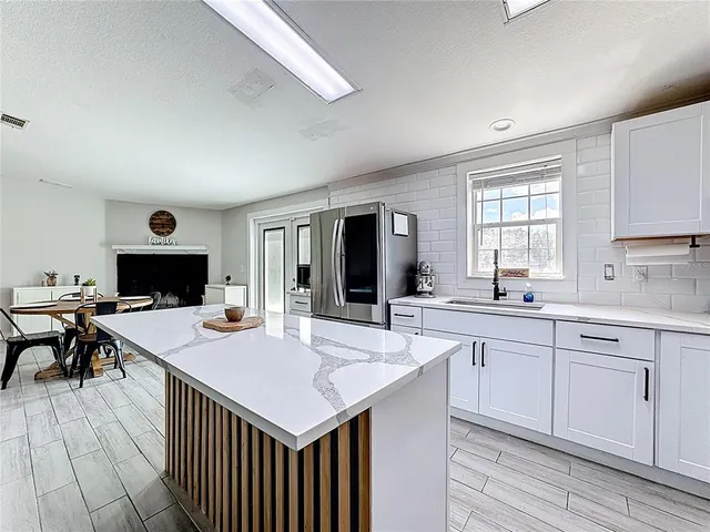 a kitchen with stainless steel appliances a refrigerator and a stove top oven