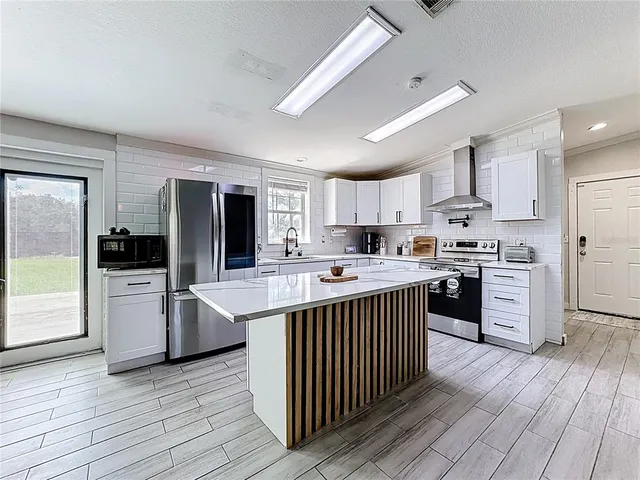 a kitchen with white cabinets and a sink
