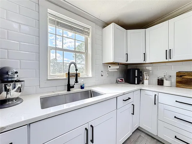 a kitchen with a sink and a refrigerator
