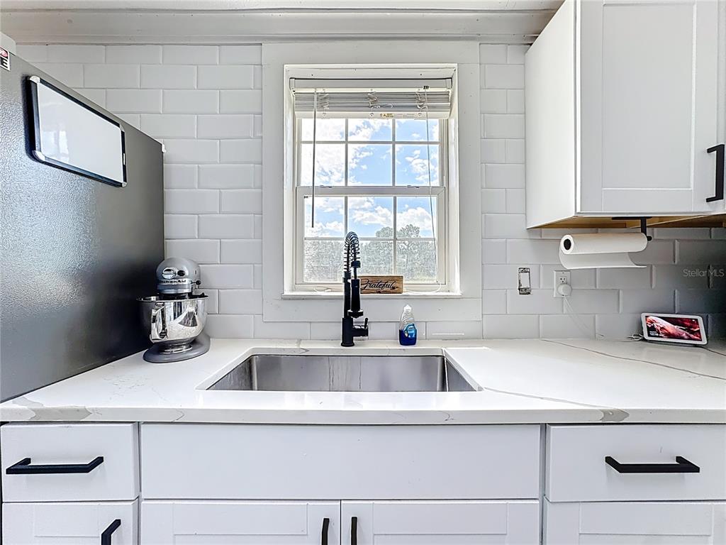 18604 Belvedere Road Orlando, FL 32820 - Photo 10 of 50 a kitchen with a sink and a refrigerator
