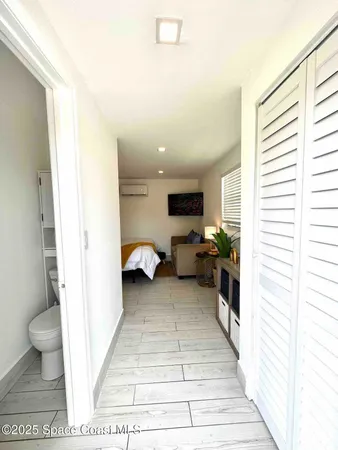 a view of a hallway with a couch and a window