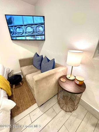a living room with furniture and a lamp