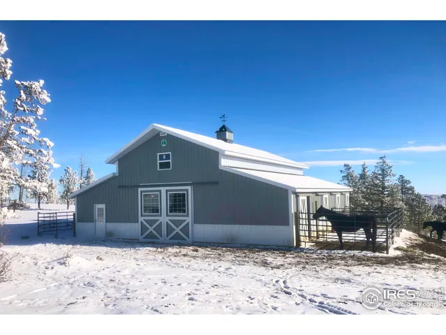 a view of a wooden house with a yard