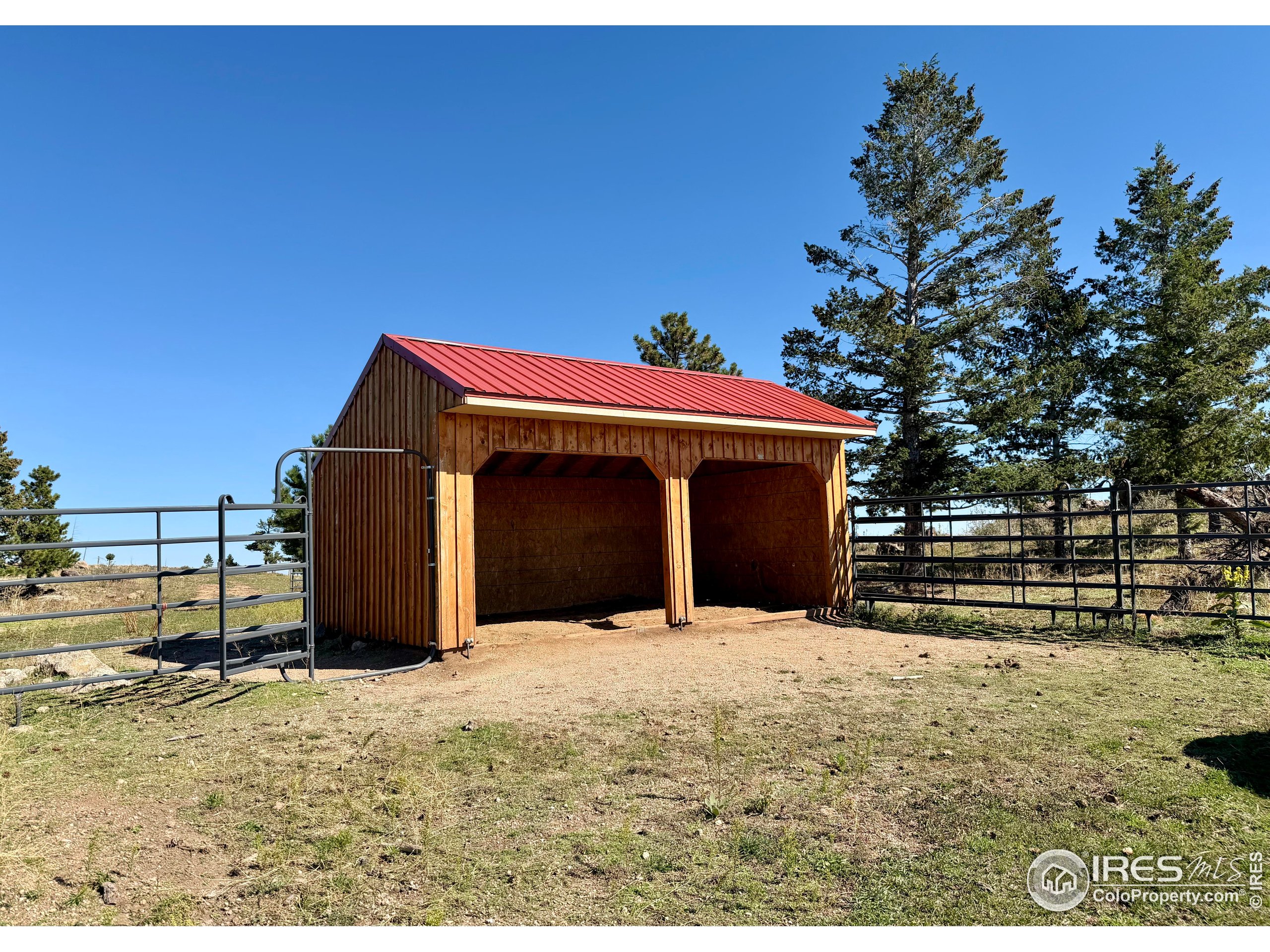 3235 Davis Ranch Road Bellvue, CO 80512 - Photo 12 of 38 a view of a wooden house with a yard